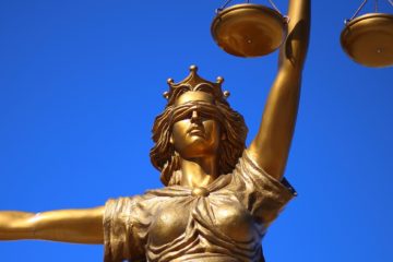 A statue of justice, blindfolded and holding a scale and sword.